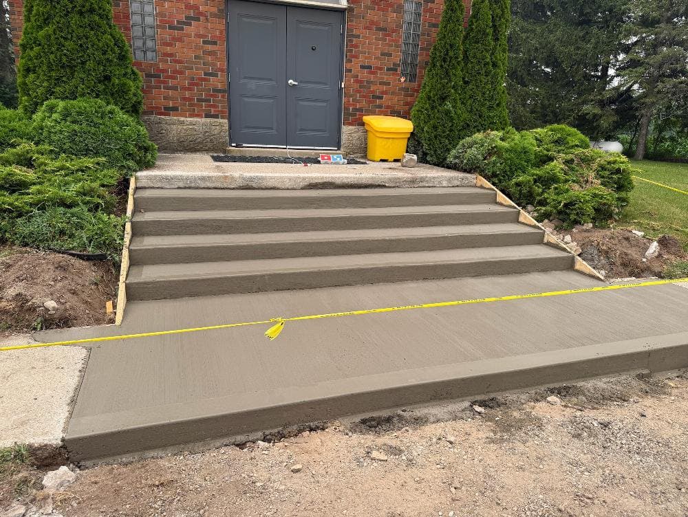 freshly finished cast-in-place concrete steps and landing poured by Ironground at a Cambridge church
