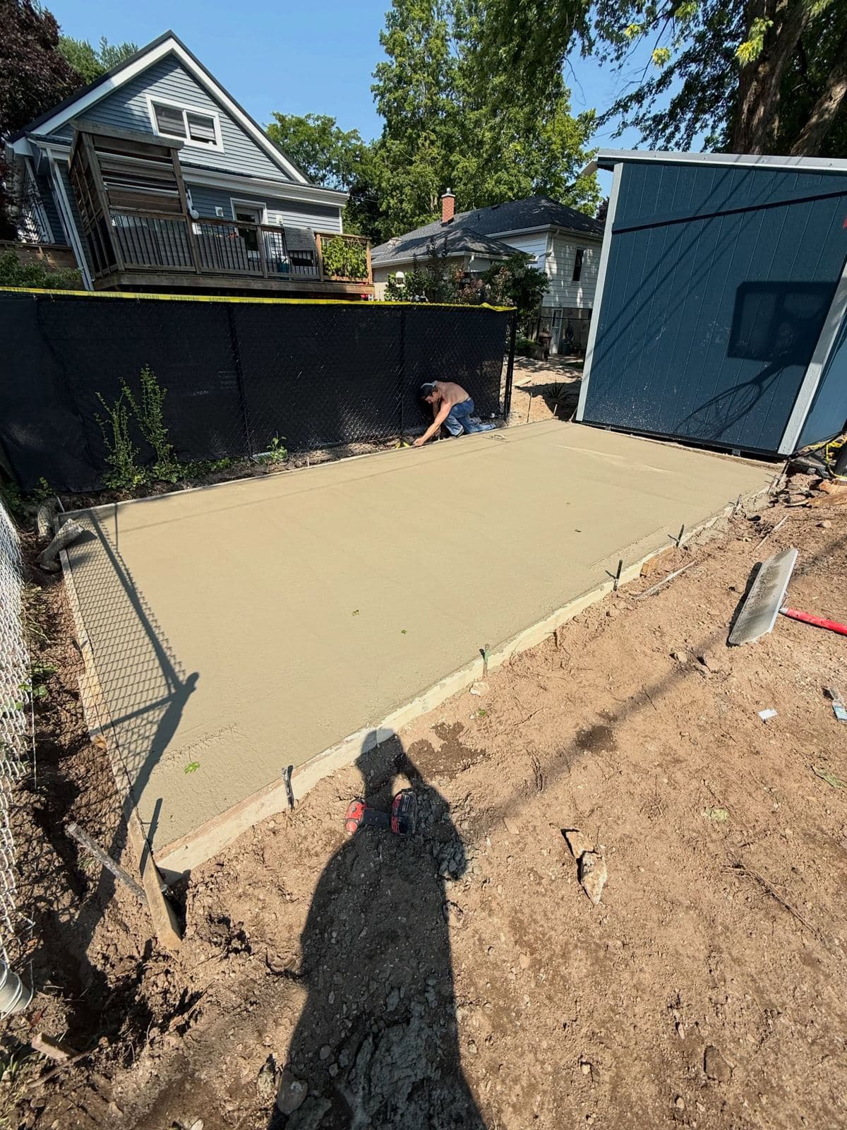 a freshly poured broom finished backyard concrete slab in Cambridge by Ironground
