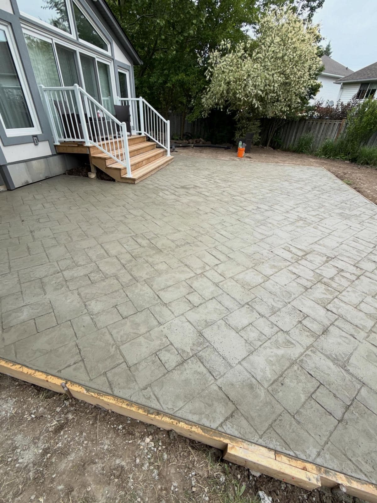 a stamped concrete back patio poured by Ironground at Havendale Place, Waterloo