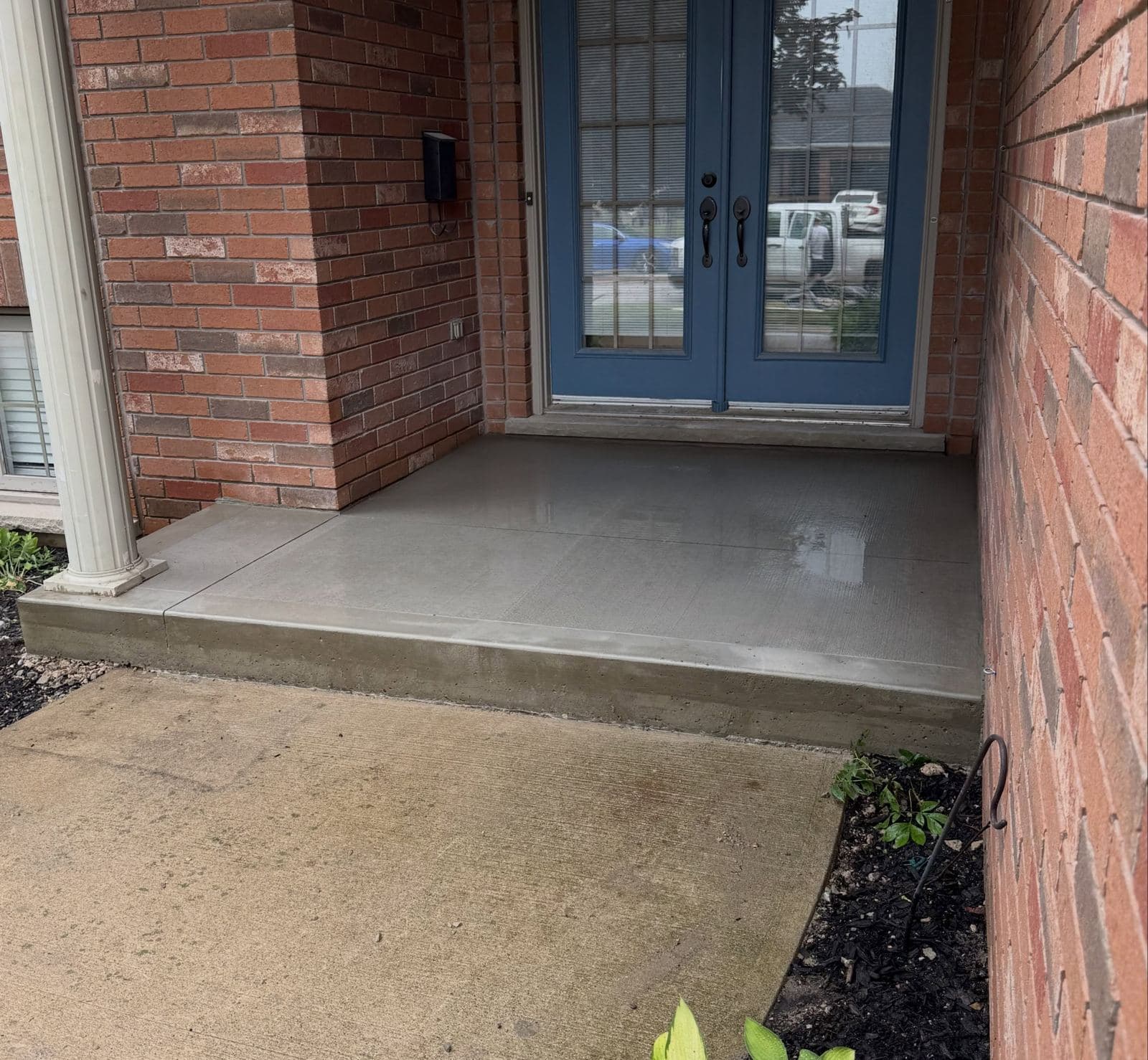a new poured concrete front porch slab in Paris, Ontario, by Ironground