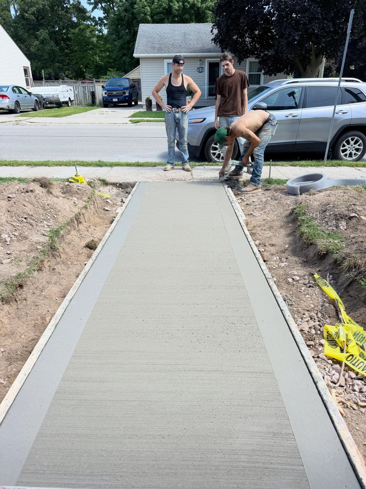 the Ironground crew finishing a fresh walkway pour