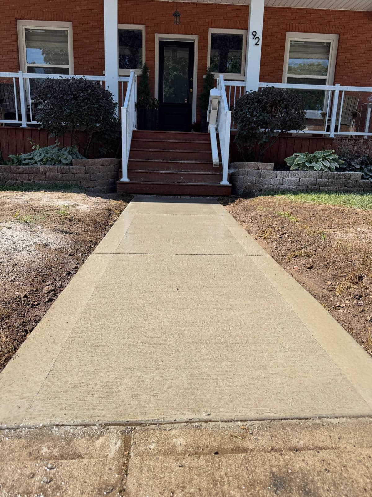 a broom finished concrete front walkway poured by Ironground on Tait Street, Cambridge